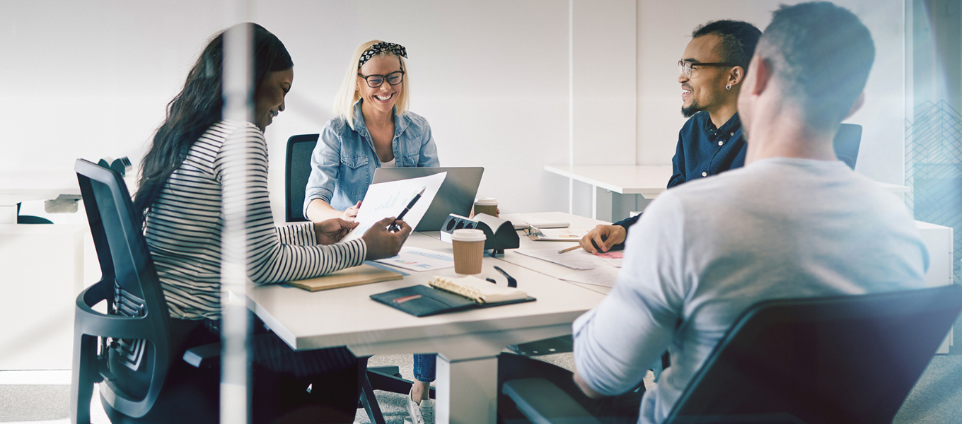 a team discussing analytics around a table